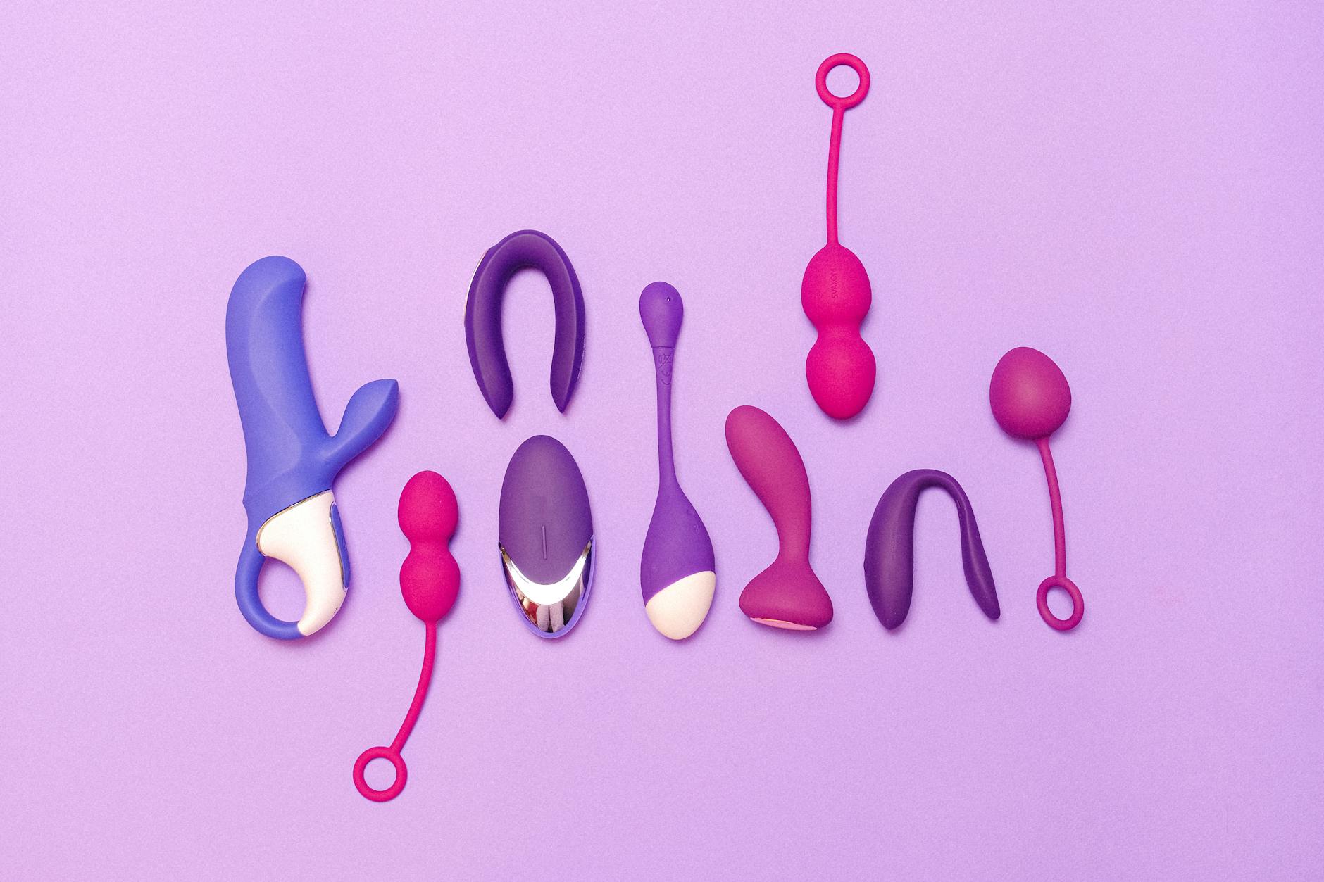 Various silicone sex toys displayed on a purple background for pleasure and education