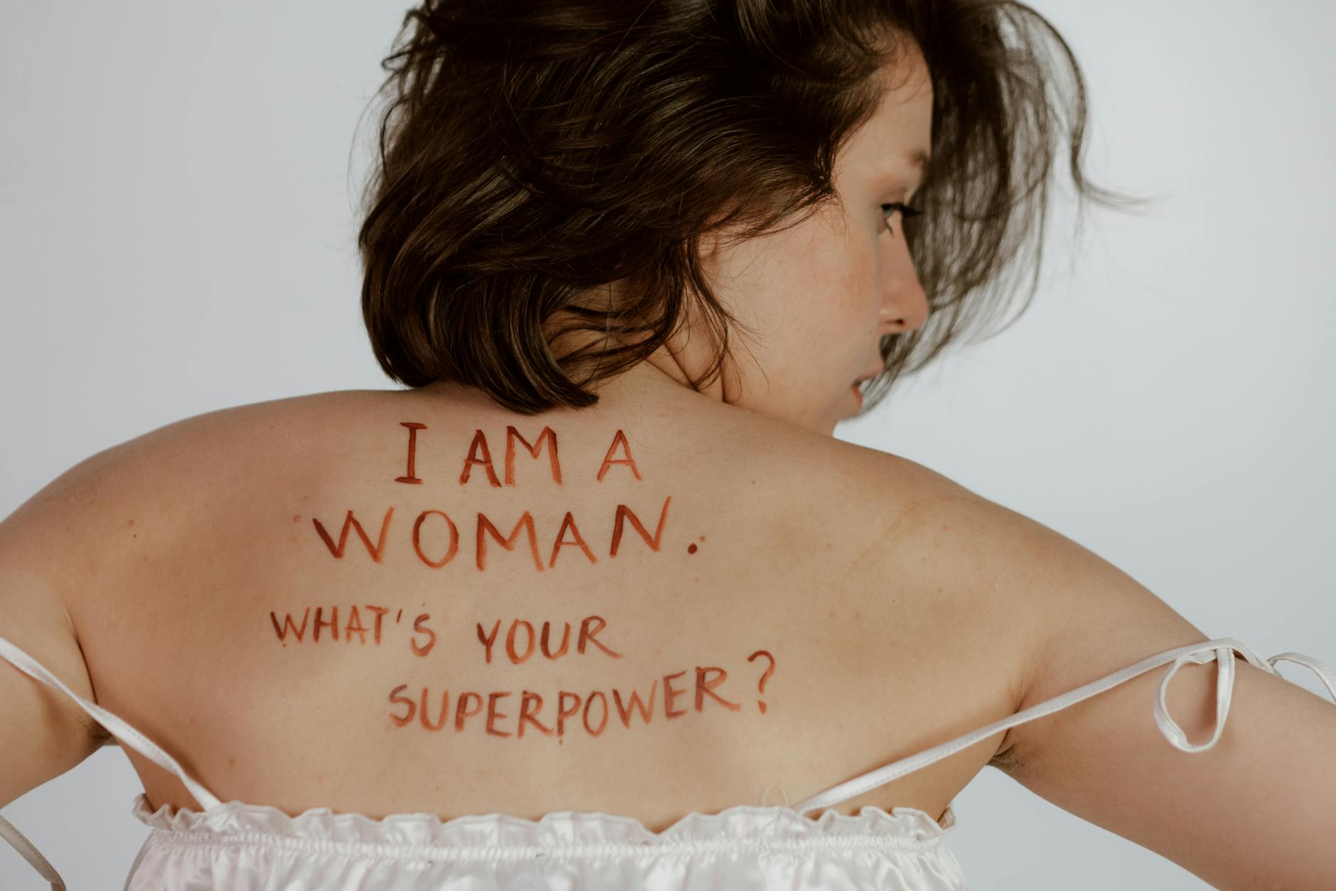 Back view of woman with empowering message, promoting self-love and feminism