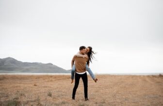 A happy couple in loving, playing around in a field