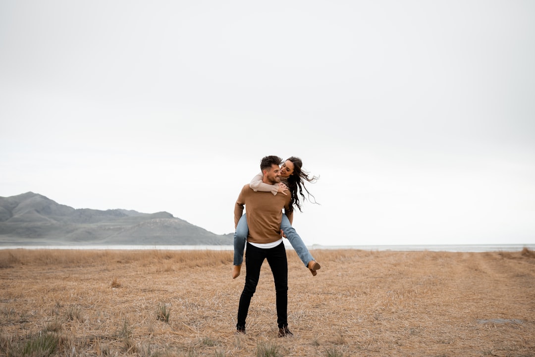 A happy couple in loving, playing around in a field